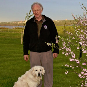 Dr Frank standing with a labrador retriever in front of him